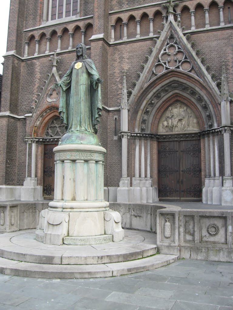 Statue in front of and part of facade Heuvel church, Tilburg, The Netherlands