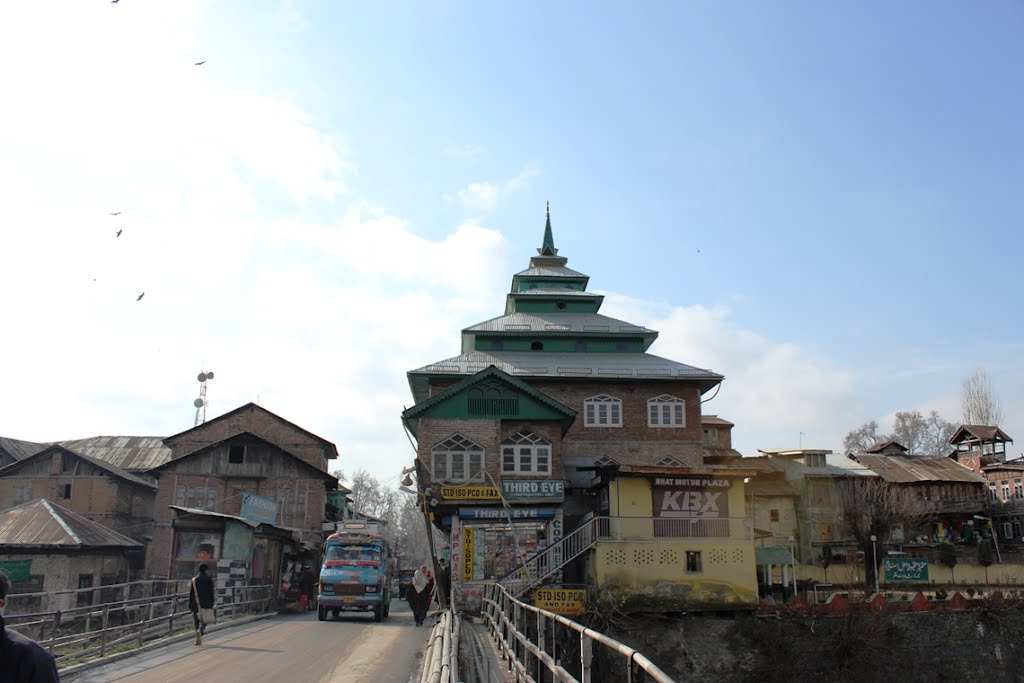 Green house beside a bridge