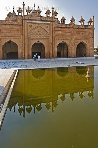 The front of the Jama Masjid is relected in the ablutions pool.