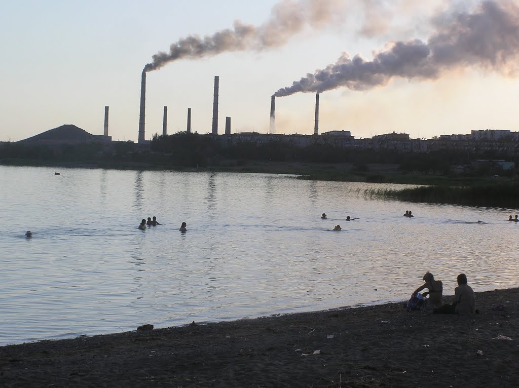 Swimmers in Lake Balkhash with Smoke Stacks in the Background