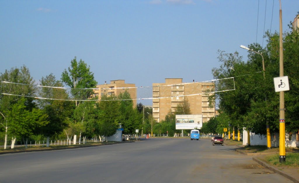 Abai avenue with abandoned houses at the background