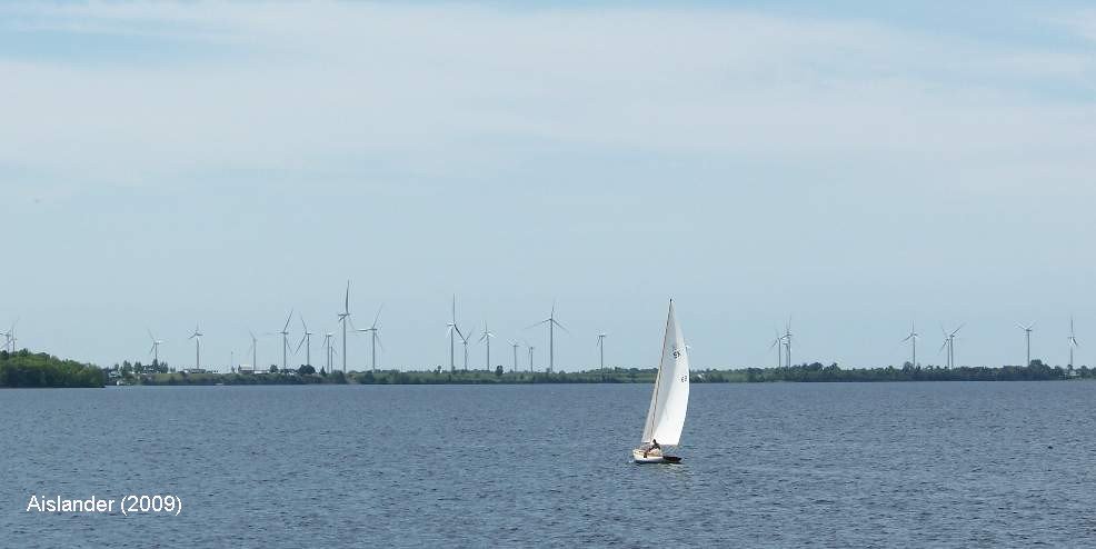 Sailboat against Wolfe Island shoreline