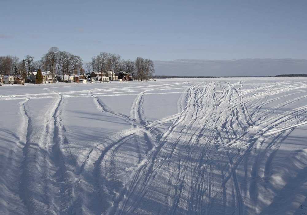 Snowmobile tracks across Pumpkin Bay, Orillia ON.