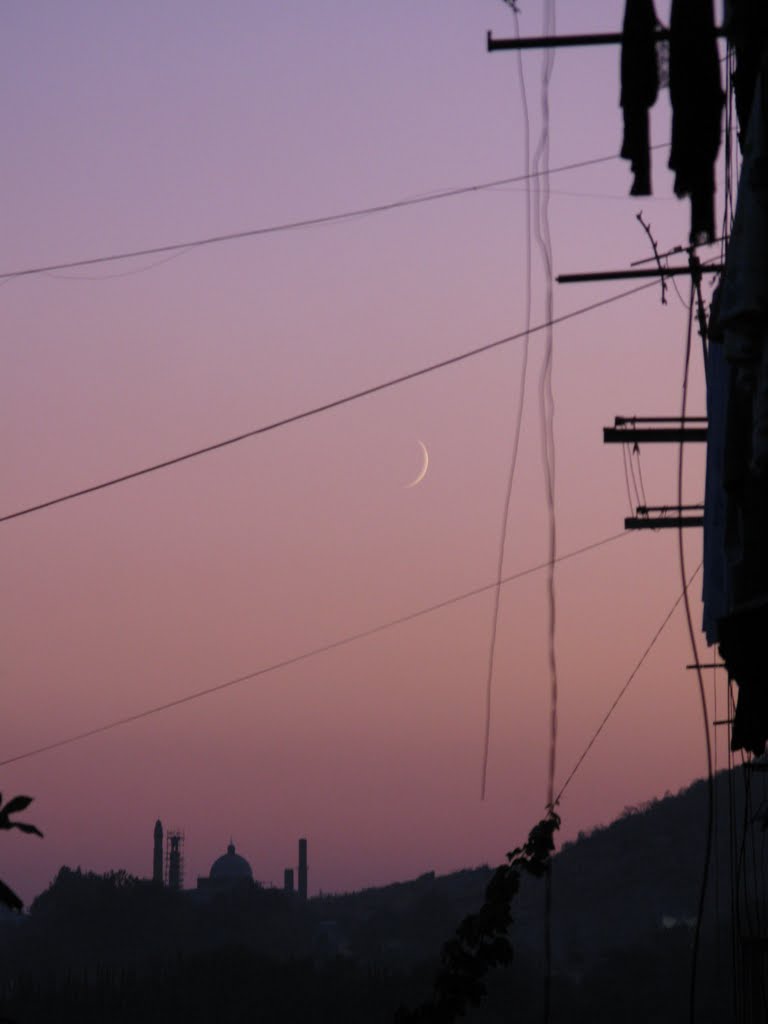 Osh, Masaliev street, view to mosque near Suleiman hill (zoom), sunset