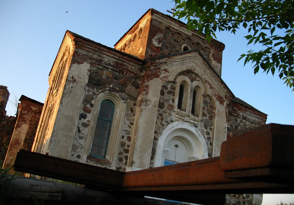 Rusty cross laying near All Saints Ortodox Church in Biahomĺ