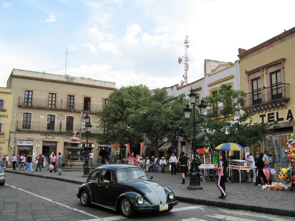 A fountain and small plaza next to the street
