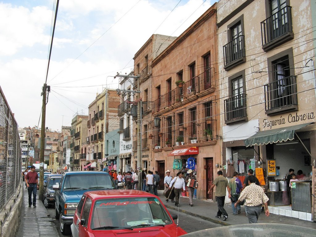Busy shopping street - behind the fence is a huge car park