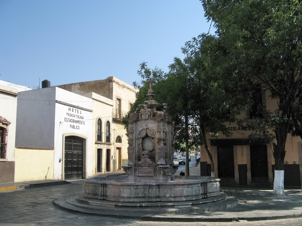 A fountain at a street corner