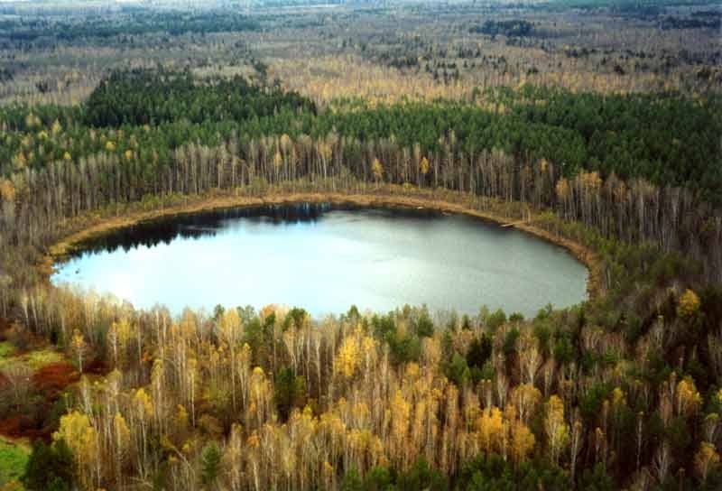Round lake by autumn
