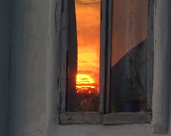 Sunset in window of house on Lenina street