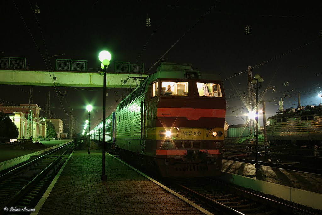 Electric locomotive ChS4T-697 with train Rostov - Adler on train station Bataysk