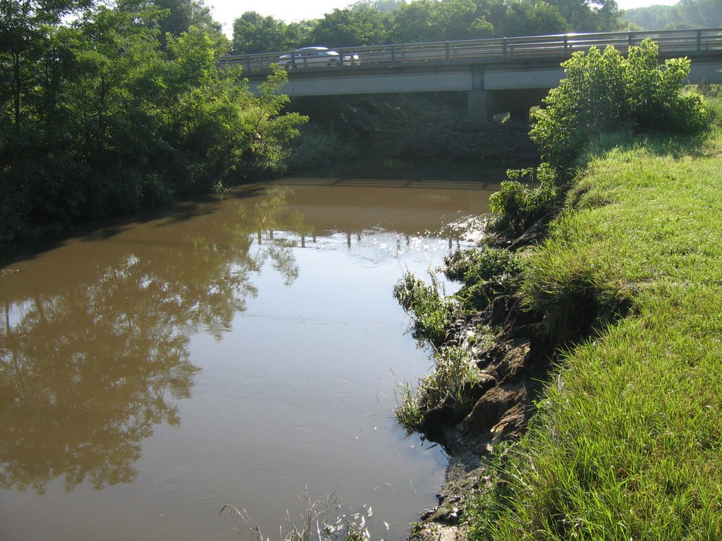 Marquette St Bridge 07/05/07. Note the debris piled up against the bridge pilings and the 6 foot drop to the normal water level. Contrast with the flood picture where the water level is right at the edge of the mown lawn of the park.