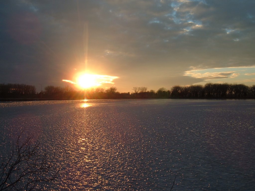 Dec 2004 - Worthington, Minnesota. Winter sunset shining on the ice of Lake Okabena.