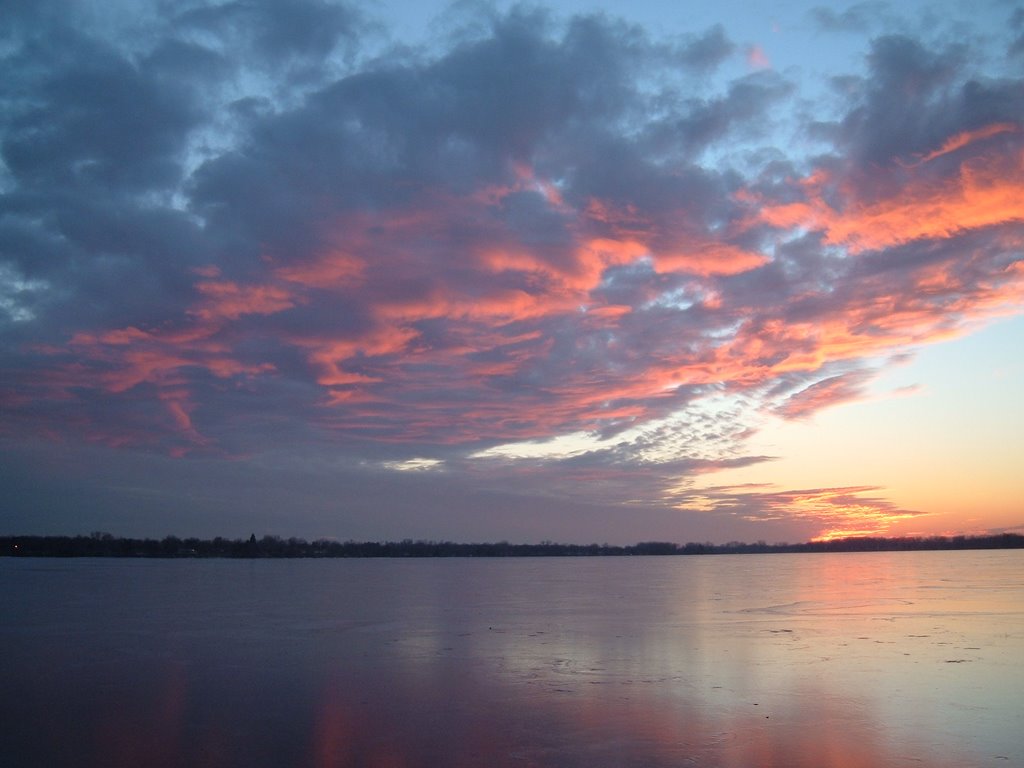 Dec 2004 - Worthington, Minnesota. Winter sunset clouds reflecting on the frozen Lake Okabena.