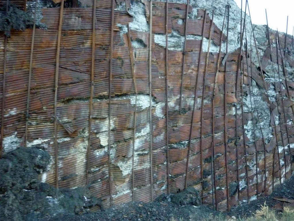 These metal walls held it in as it built up over the years.