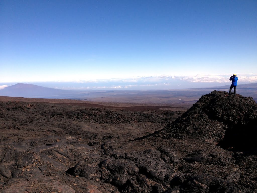 2012-04-29 Distant hiker observes Hualalai volcano from Mauna Loa slopes.