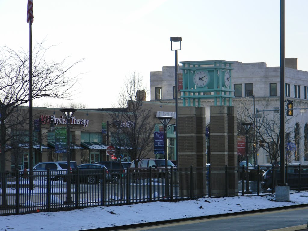 Clock Tower and Stores by Railroad Tracks