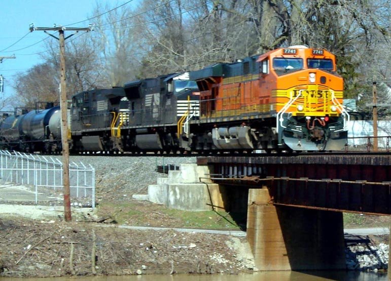 BNSF 7741 leads a train across the Mississinewa River bridge.