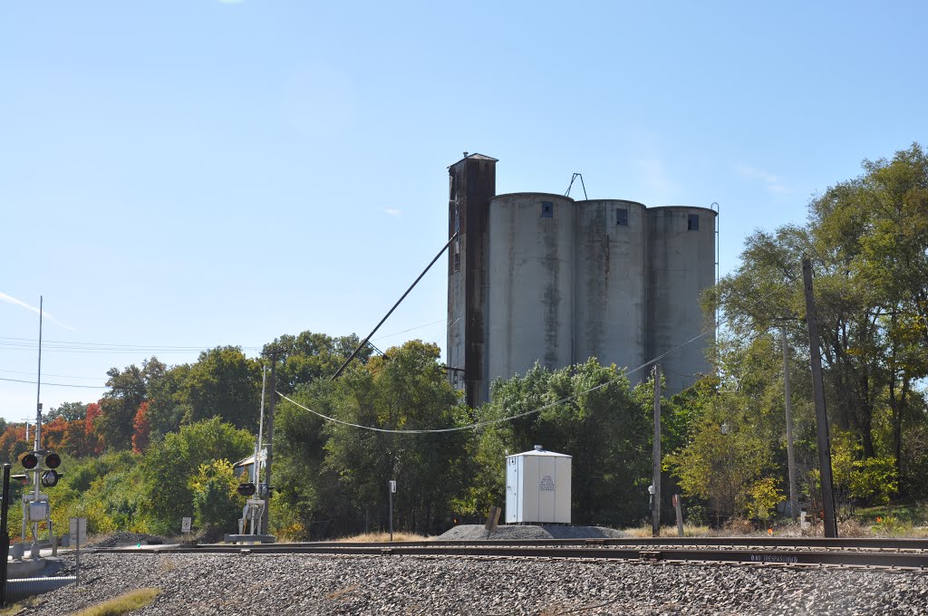 Old grain elevator next to railroad tracks