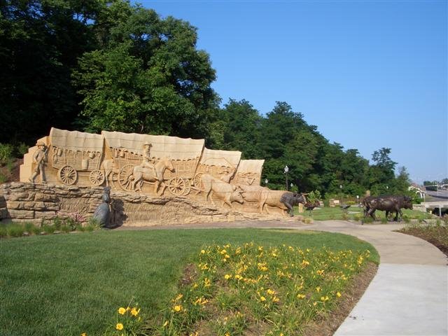 life-size wagon train in clay, bronze woman & child, oxen, Pioneer Crossing Park, Shawnee, KS