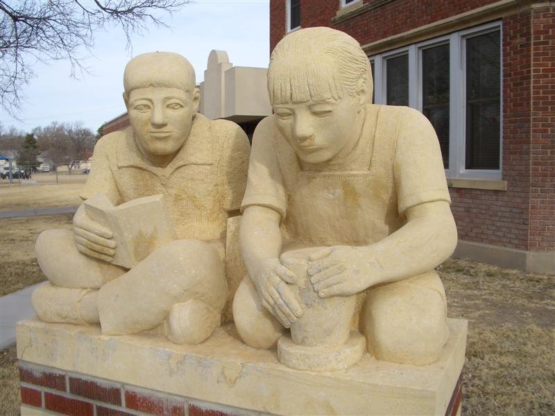 Boy & Girl life-size limestone Pete Felten sculptures, Hays, KS