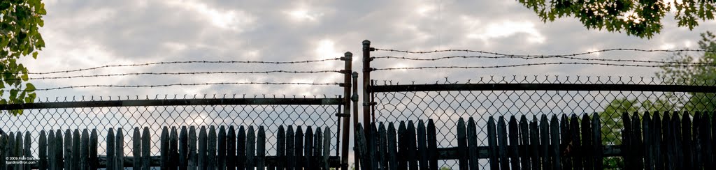 Wooden Fence with Barbed Wire