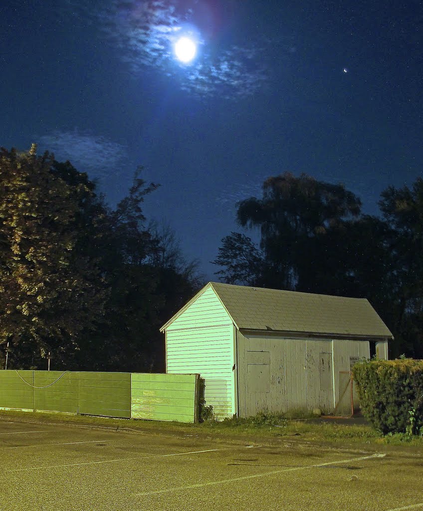 Moon  and planet Jupiter rising over shed on evening of September 23, 2010.