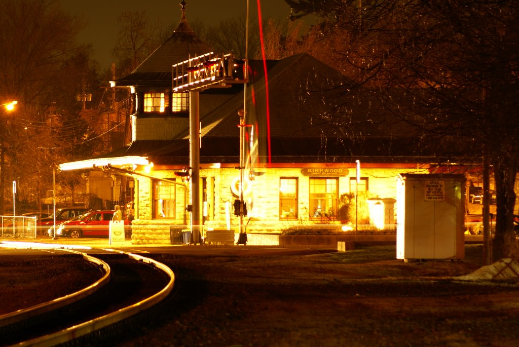 Light splashed on the Kirkwood Station as an east bound train approaches.