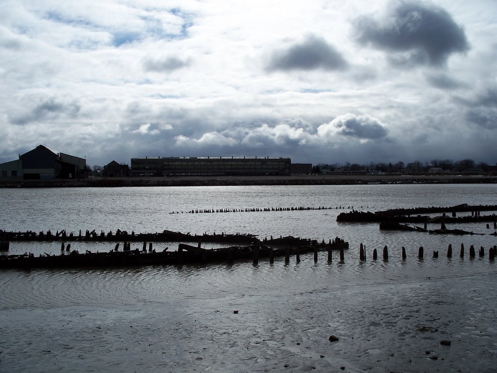 Decaying boats and buildings and a break in the clouds