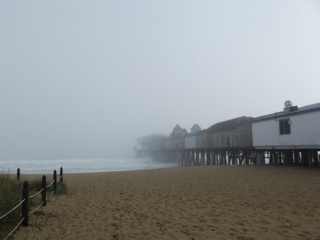 The pier disappears in the fog.