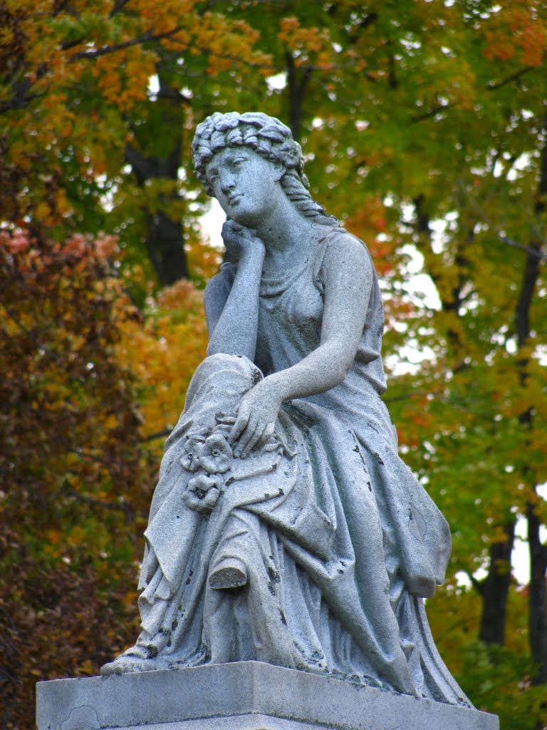 Sitting stone Lady in fall