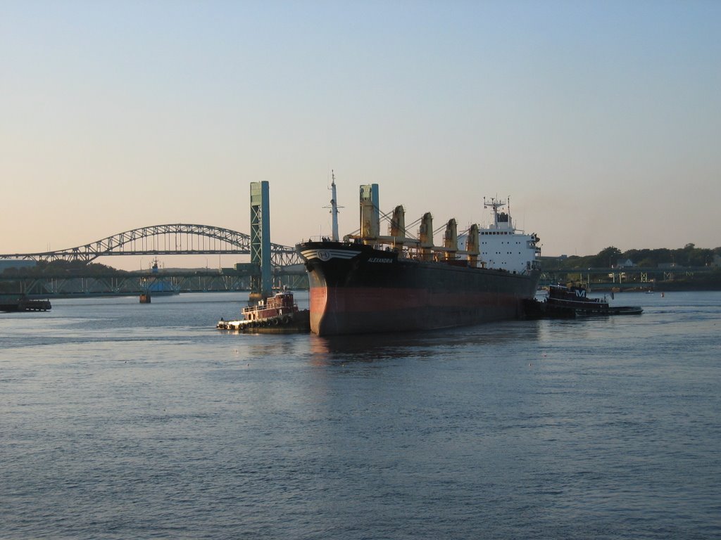 Tug Boats Guiding a Large Ship