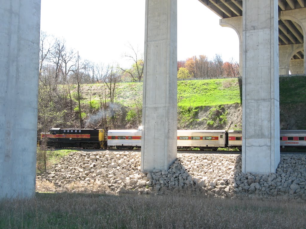 a ten-car/two-engine Cuyahoga Valley Line train slips under the Ohio Turnpike