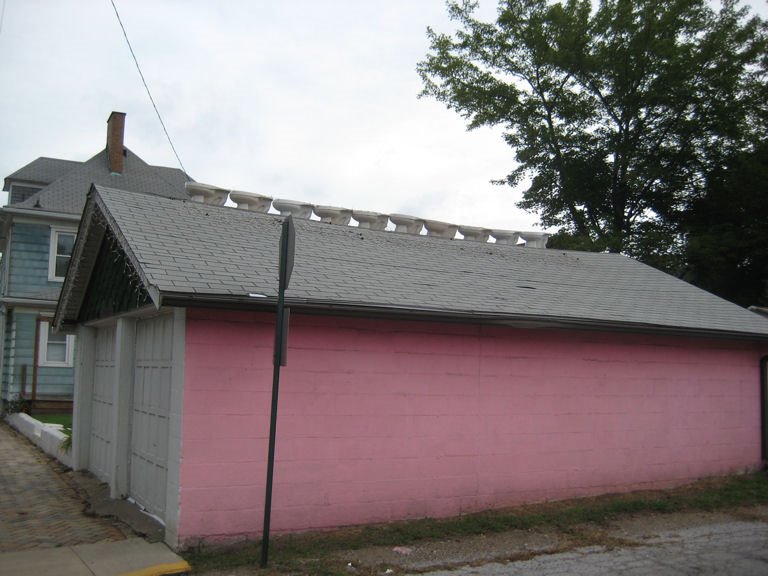 Pink garage with toilets on the roof