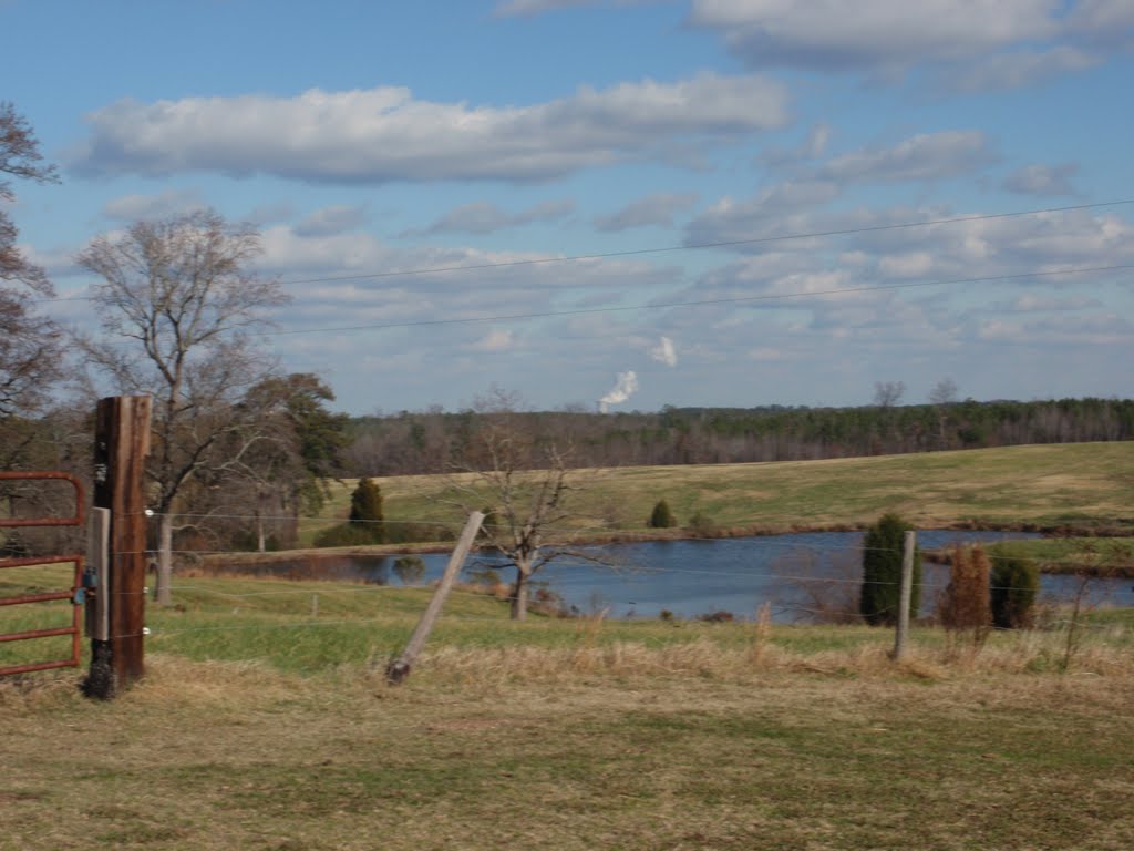 rolling hills of Lee County descending into the Deep and Cape Fear River valley, with a farm pond in the foreground and steam from the Shearon Harris Nuclear Power Plant cooling tower in the distance, 12-5-10