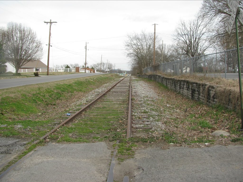 Road, rails, and rock wall