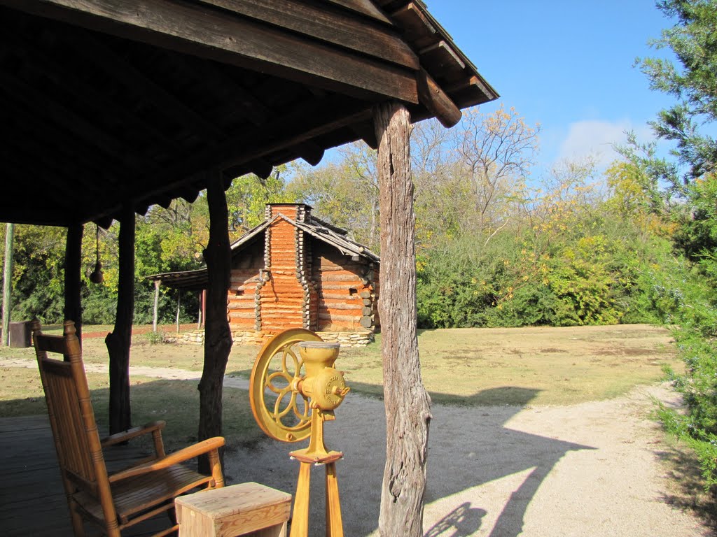 Grist Mill and rocker on porch; log cabin in background