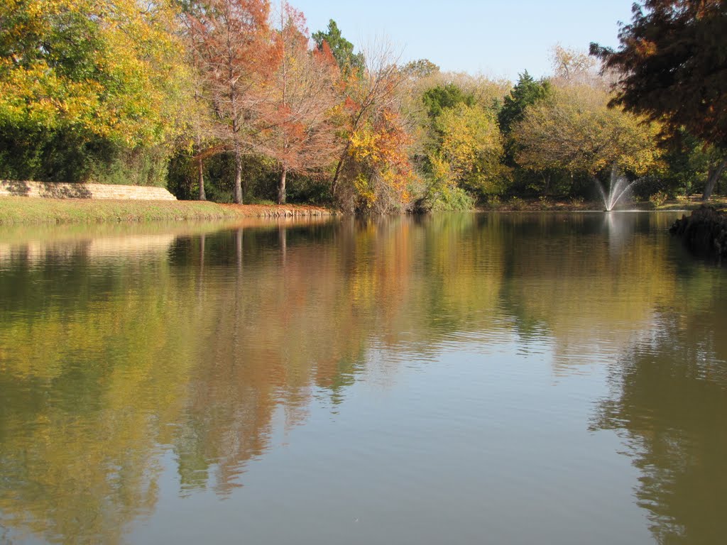 Reflection of autumn-colored trees in the water of the pond