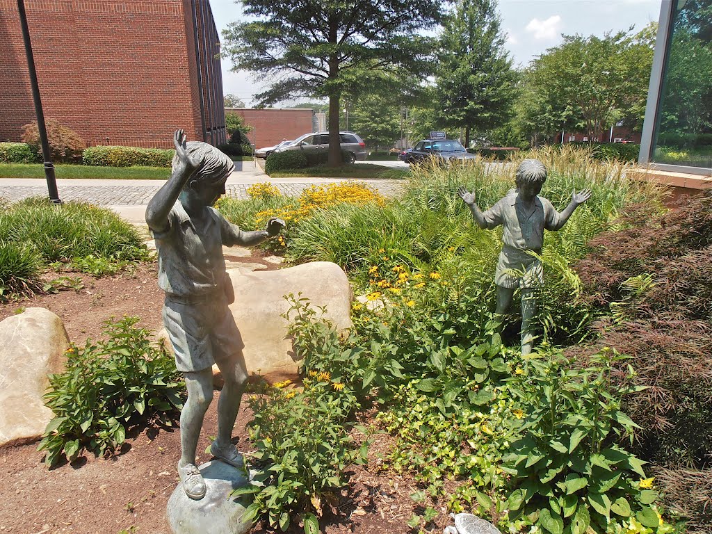 Boys exploring statues