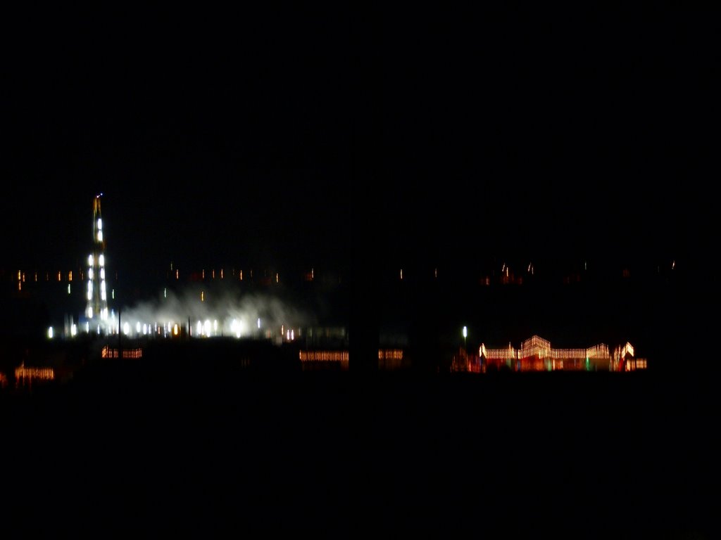 Oil rig, out of focus, in the cold night.