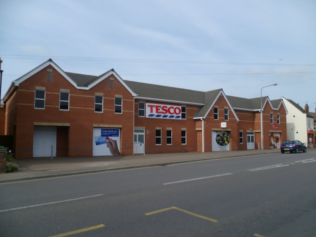 tesco supermarket, made to look like a row of small shops, the type they have destroyed. gaywood, kings lynn, norfolk, june 2012.