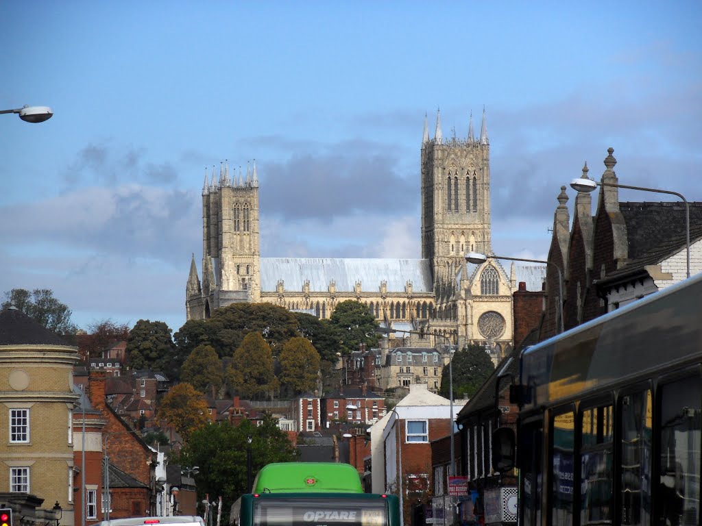 Long view down Lincolns High Street on a cold Autumn afternoon. The brief sunny spell enhances St Marys stonework.
