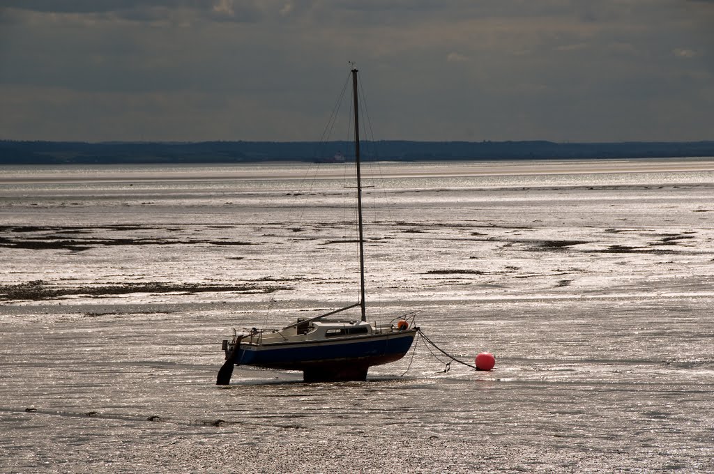Boat beached on mud flats