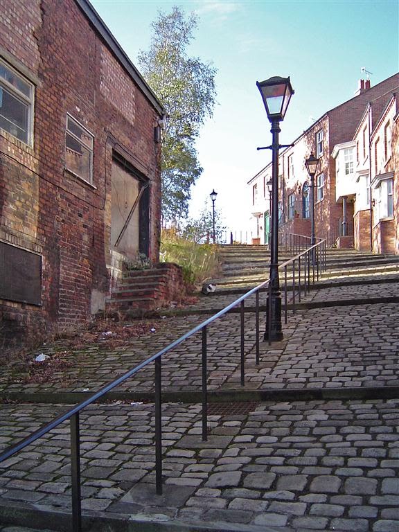Gas lamps in a Stockport cobbled street