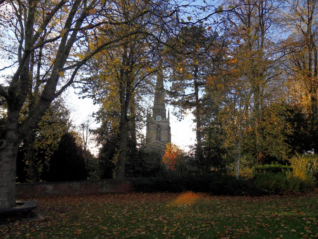 Autumn through the trees to the church at Hinckley