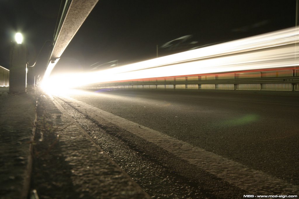 car crossing bridge at night